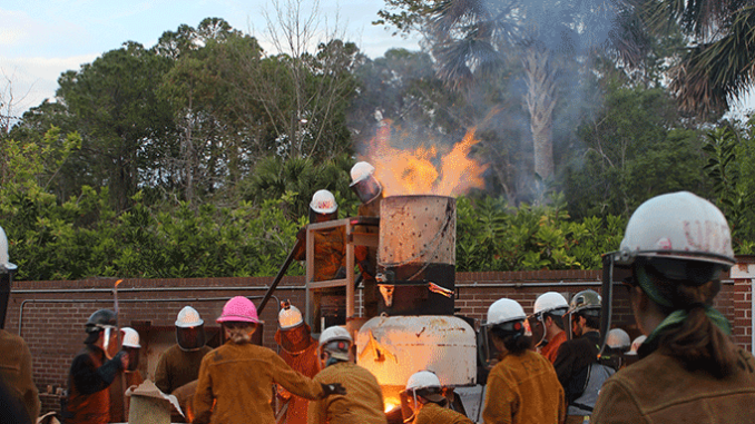 Tapping the furnace and spilling iron